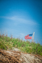American flag on a flag pole on a hill 
