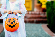a child in a princess costume trick or treating 