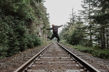 jumping high above train tracks