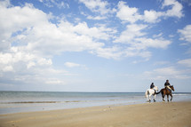 riding horses on a beach 