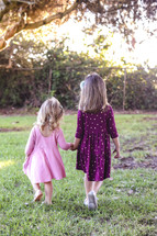sisters walking holding hands 
