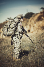 army soldier in the field holding a rifle