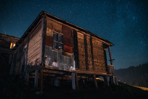 Old hut and starry sky