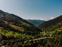 Amazing view to mountains covered pine trees, clouds. Drone view. Summer in Europe Carpathians. Concept of flight, nature, breathtaking beauty of our planet. High quality photo