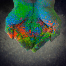 Top view of colored powder in the hands. 