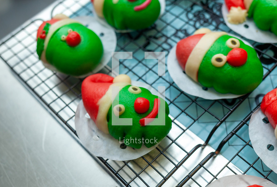 Green steamed buns with Christmas hats
