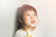girl eating a banana 