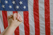 praying hands and American flag 