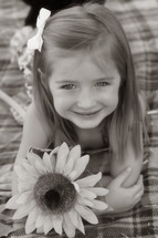 toddler girl portrait with a sunflower 