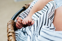 newborn feet in a bassinet