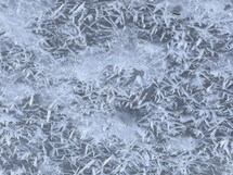 Snowflake pattern on frozen lake