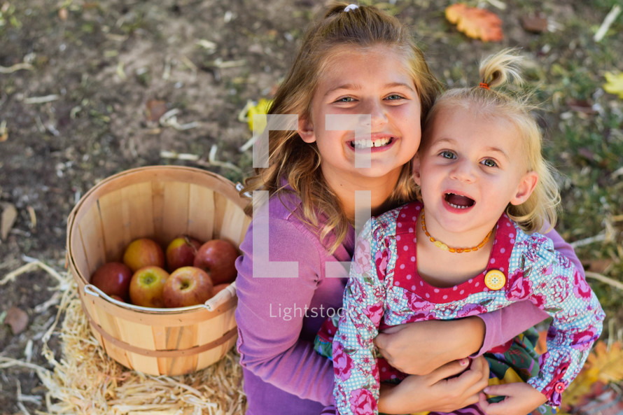 sisters with a basket of apples 