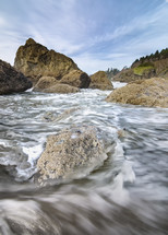 tide flowing through rocks onto a shore 
