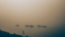 People canoeing into the mist