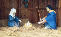 Plastic nativity scene on hay