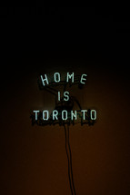 Neon sign saying Home is Toronto