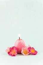 an easter egg candle and flowers 