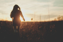 girl walking in a field