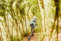 a kid walking through a forest 