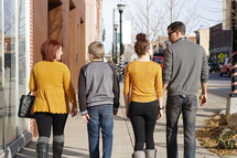 family walking down a sidewalk 