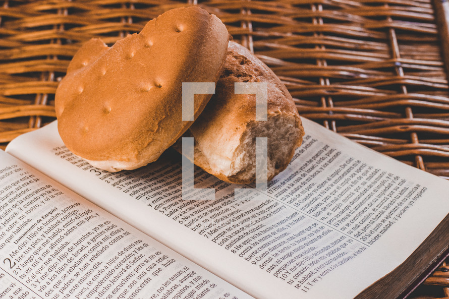 broken bread on the pages of a Bible in a basket 