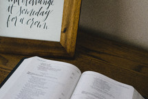 pages of an open Bible on wood table 