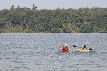 padding in kayaks on a lake 