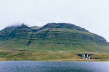tall green mountain peaks along a coastline 