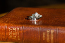engagement ring and wedding band on a Bible 