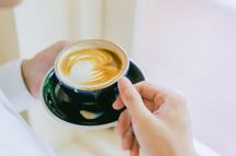 a man holding a latte 