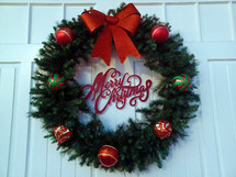Merry Christmas wreath on a white door background