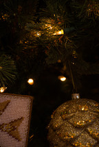 gold Christmas ornaments on a Christmas tree 