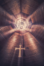 rays of sunlight from skylights in the ceiling of a church 