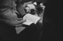 an elderly man reading a Bible 