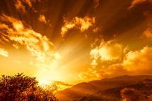 Golden rays of sun over a mountain range.