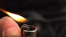 A lighter ignited and its flame shot in slow motion.
