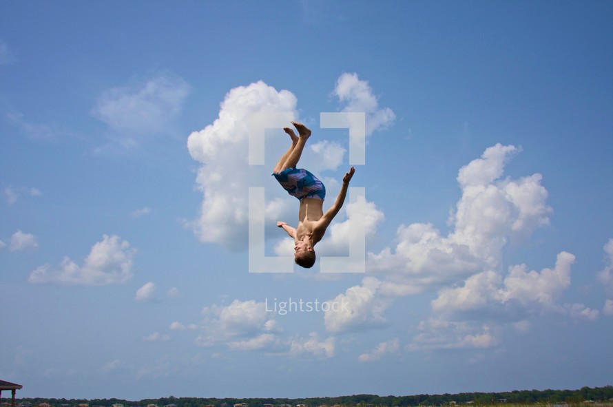 boy doing flip - sky background