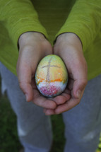 cupped hands with an Easter egg 