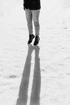 legs and shadows standing in snow 