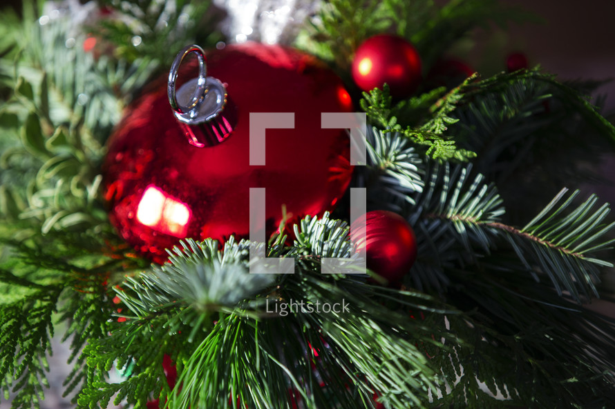 red Christmas ornament in greenery 