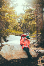 a female hiker resting on a rock 