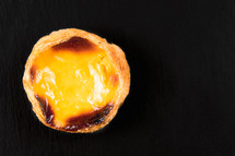 Top view Egg Tarts or pasteis de nata  on black background. Typical portuguese sweet
