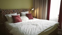 Comfort bedroom in luxury style. Hotel bedroom interior in the morning. Hotel room with modern interior.