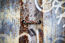 rusty chain and graffiti on metal 