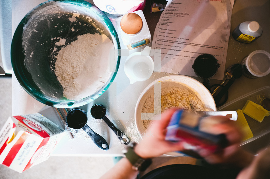 woman making pancake batter in a kitchen 