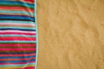 striped beach towel on the sand 
