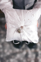 ring bearer holding a pillow with wedding rings