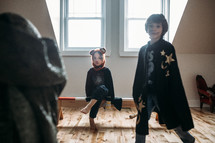 boys in costumes in a playroom 