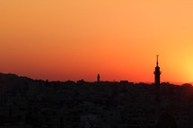 Silhouette of a mosque and city