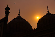 Silhouette of a mosque at sunset